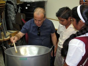 Ali being introduced to the steelpan during visit to school in Victoria District